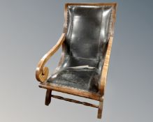 A Victorian style scroll armchair.