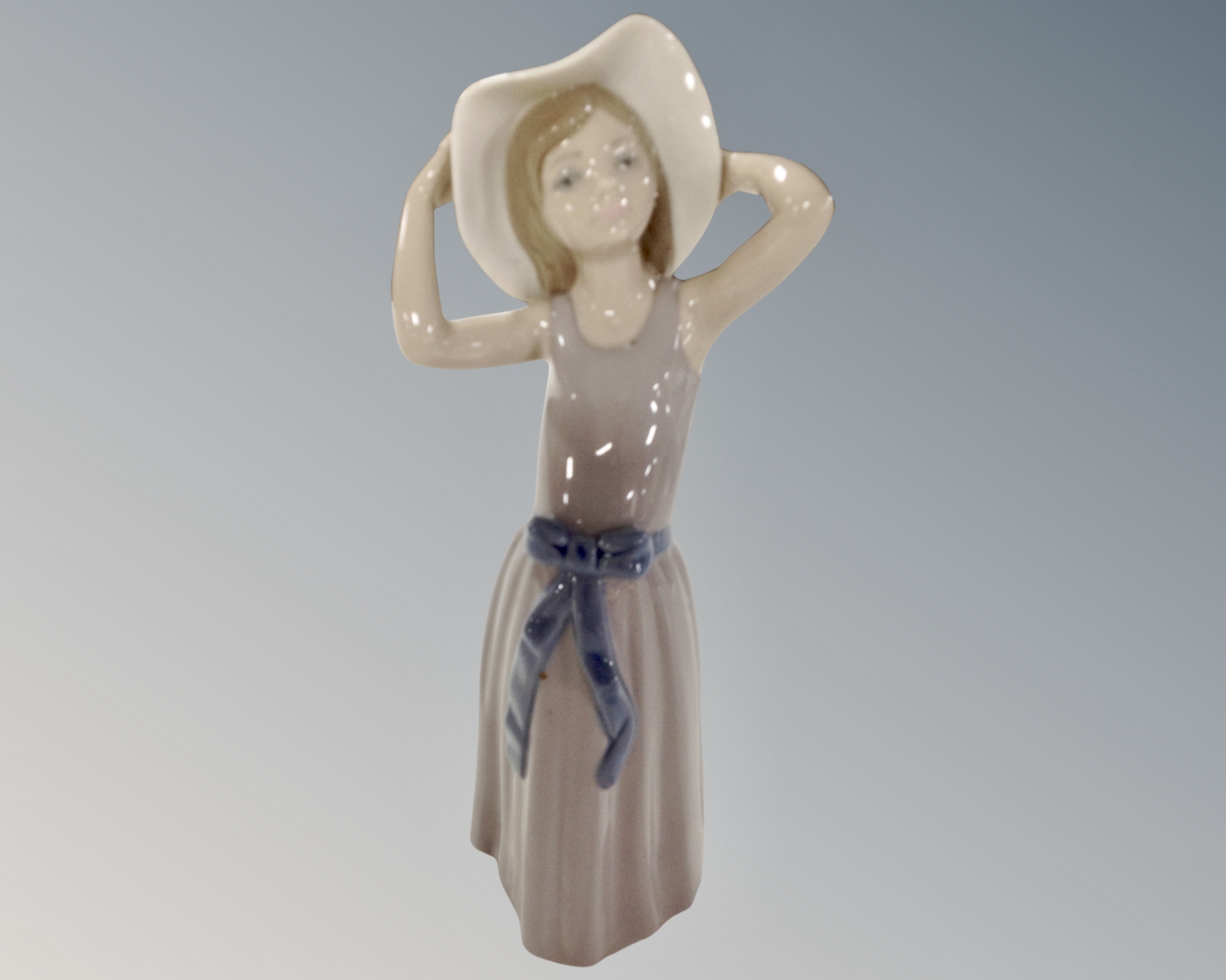 A Lladro figure, girl with hat.