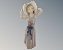 A Lladro figure, girl with hat.