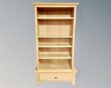 A contemporary open bookcase on stand fitted with a drawer (width 99cm)