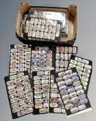A box containing a large quantity of reproduction cigarette cards in mounts.