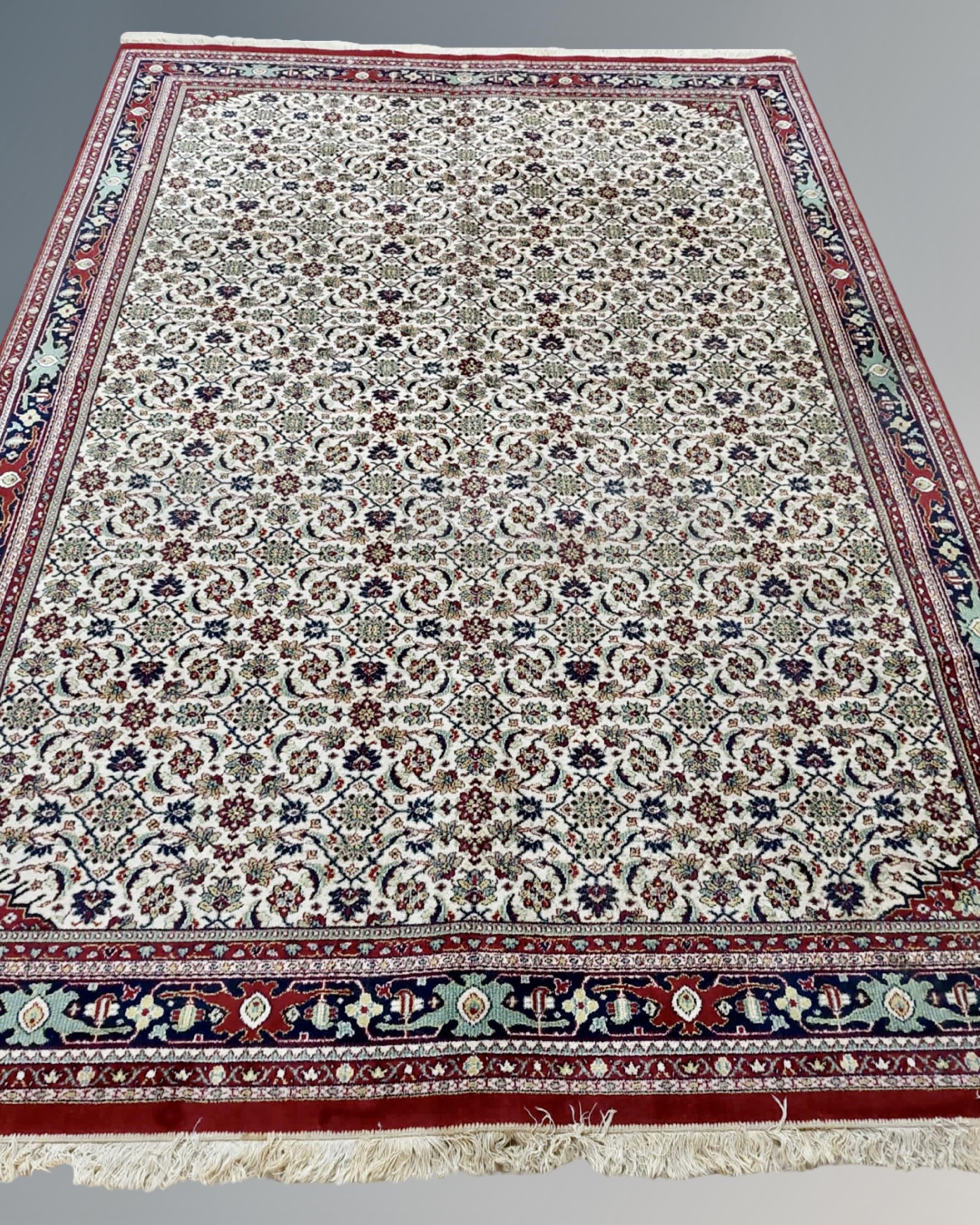 A machine made carpet with all-over Herati motif on cream ground,