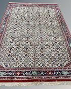 A machine made carpet with all-over Herati motif on cream ground,