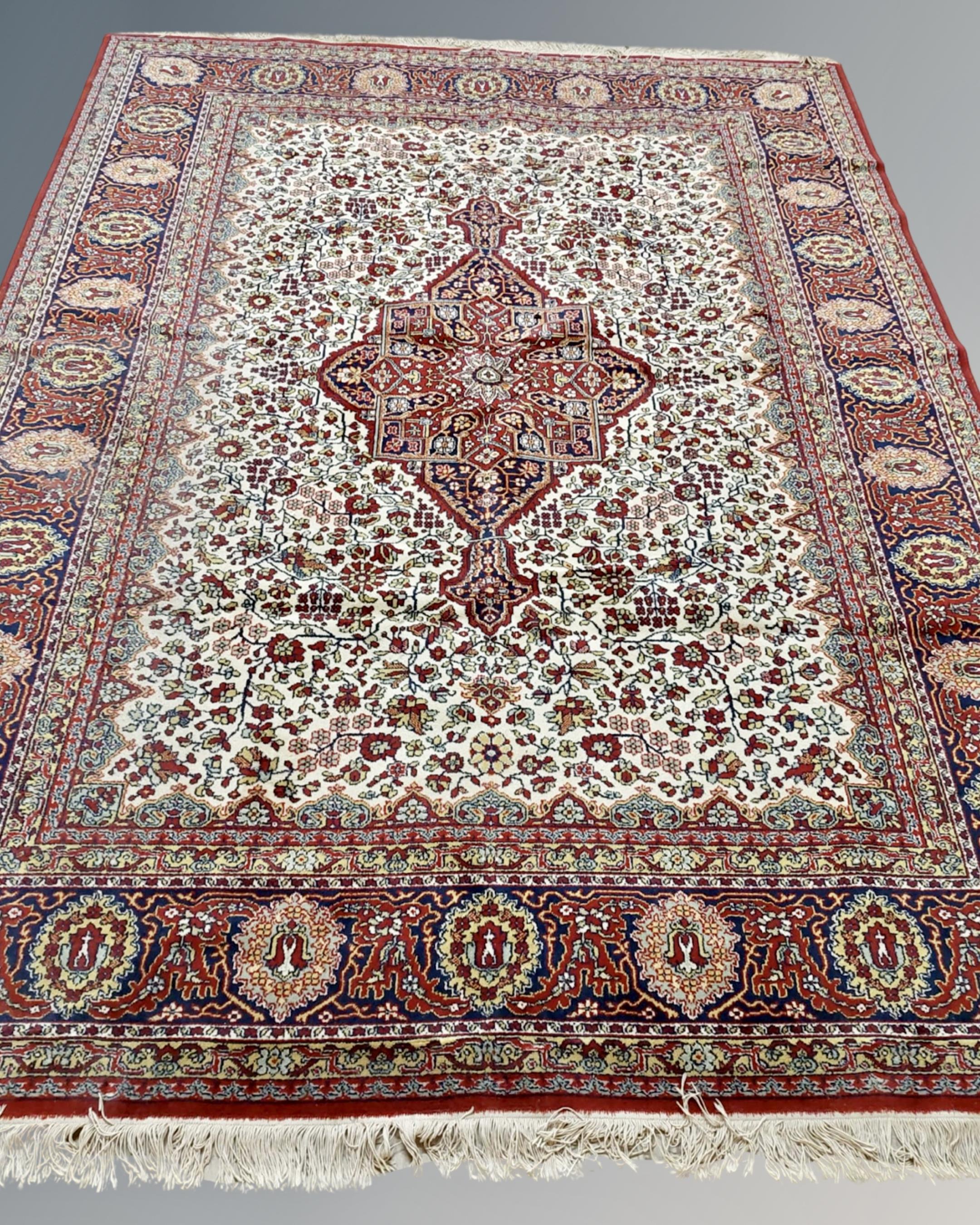 A Heriz-style carpet, probably Indian, on red and cream ground,