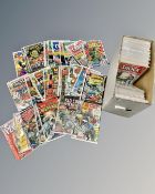 A box containing a collection of vintage comics including DC's Black Lightning,