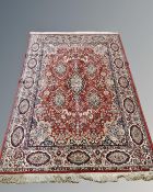 A Persian design rug on red ground, probably Indian,
