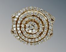 An 18ct gold fancy diamond cluster ring set with approximately 135 diamonds, size M½.