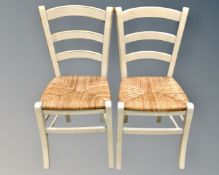 A pair of farmhouse style rush seated dining chairs.