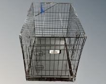 A Confidence folding pet cage with tray.