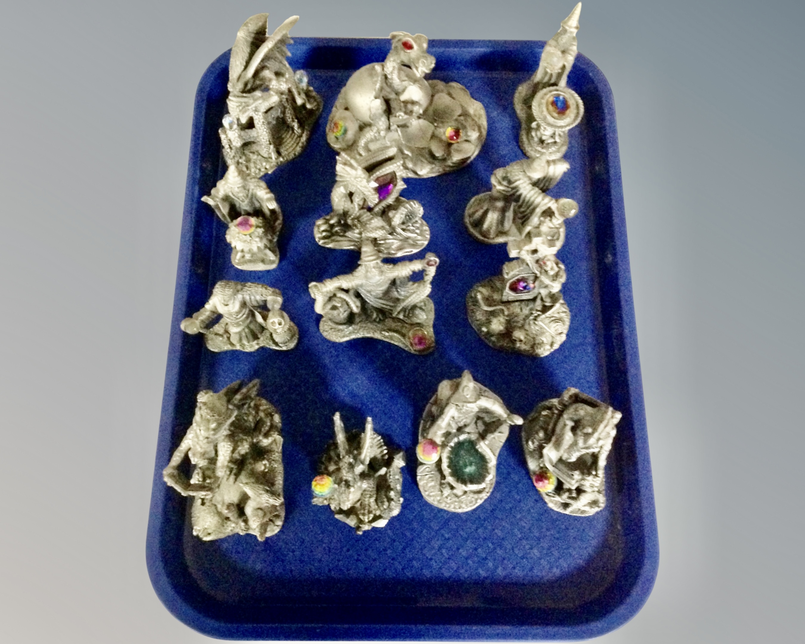 A tray containing 13 pewter figures with crystals including The Visionary, The Awakening,