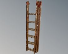 A vintage wooden three section extending ladder.