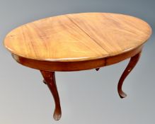 A late 19th century continental mahogany oval dining table on cabriole legs.