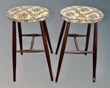 A pair of stained beech bar stools with tapestry seats.