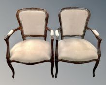 A near pair of stained beech French salon armchairs