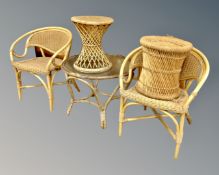 A circular bamboo and wicker glass topped table together with two wicker and bamboo occasional