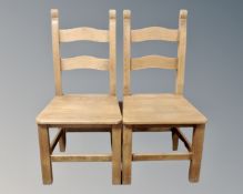 A pair of pine farmhouse dining chairs.