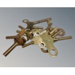 A collection of 13 vintage and antique brass clock keys.
