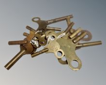 A collection of 13 vintage and antique brass clock keys.