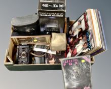 A box containing vintage cameras, vintage desk clock, a pair of Scheffel binoculars,