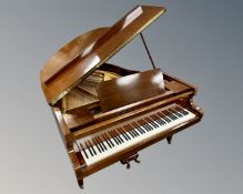 A mahogany baby grand piano by Daneman.