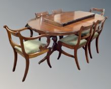 A Regency style oval twin pedestal dining table with leaf, together with a set of six chairs,