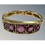 A 9ct gold five stone ruby ring, R½, 3.1g.