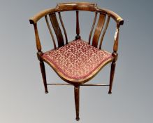 A Victorian inlaid mahogany corner armchair, on cross-over support and tapered legs,