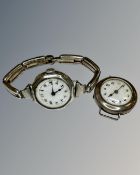 Two vintage silver watches one on silver strap.