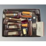 A box containing various pipes, cheroot holders, cigars and cigar cutters, Dunhill lighter etc.
