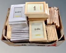 A box containing a quantity of Xenos picture frames in various colours,