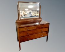 An Edwardian mahogany four drawer dressing chest on raised legs (width 106cm)