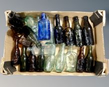 A box of a collection of antique bottles bearing advertisement