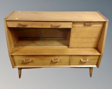 A mid-20th century G Plan E. Gomme sliding glass door sideboard fitted with drawers.