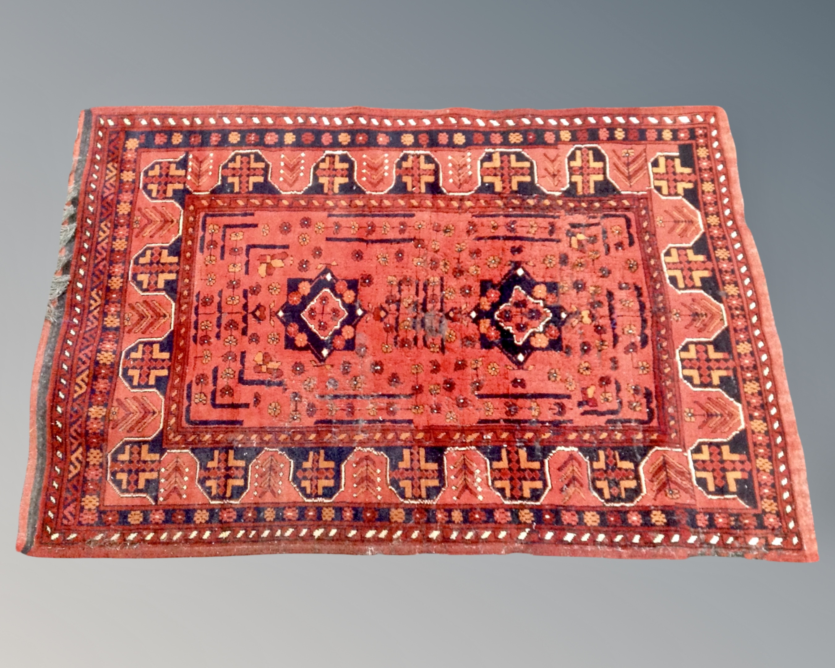 An Iranian woolen rug on red and black ground,