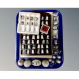 A collection of assorted china thimbles, thimble rack, three piece ceramic cruet set,