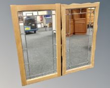 A pair of leaded glass mirrors in blond oak frames.