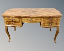 An early 20th century Italian walnut parquetry writing desk on cabriole legs fitted with five