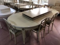 A cream and silver coloured extending dining table with five leaves, total length 450 cm,