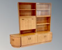 A 20th century teak G Plan twin section secretaire bookcase with matching corner cupboard.