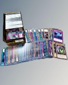 A tin containing a quantity of Yu-Gi-Oh trading cards from various sets,