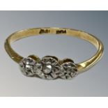 An 18ct yellow gold platinum set three stone diamond ring, size P, 1.7g.