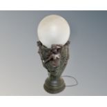 An Art Nouveau style cast plaster table lamp with clouded glass shade.