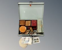 A metal deed box containing a gavel, a pair of spurs, a watch, a lapel badge, a padlock & keys,