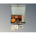 A metal deed box containing a gavel, a pair of spurs, a watch, a lapel badge, a padlock & keys,