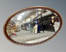 An Edwardian oval framed bevel edged mirror.