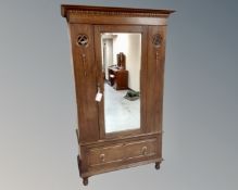 An Edwardian oak mirror door wardrobe,