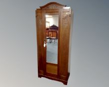 An Edwardian oak mirror door wardrobe (width 86cm)