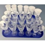 A tray of assorted drinking glasses to include a set of twelve lead crystal wine glasses