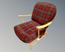 An Ercol elm and beech armchair upholstered in a checked fabric.