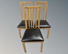 A set of six contemporary high backed dining chairs.
